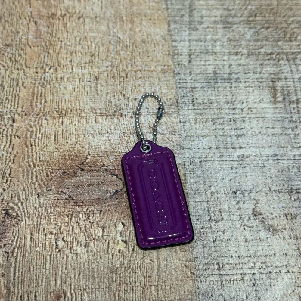 Vibrant purple coach replacement bag charm hang tag